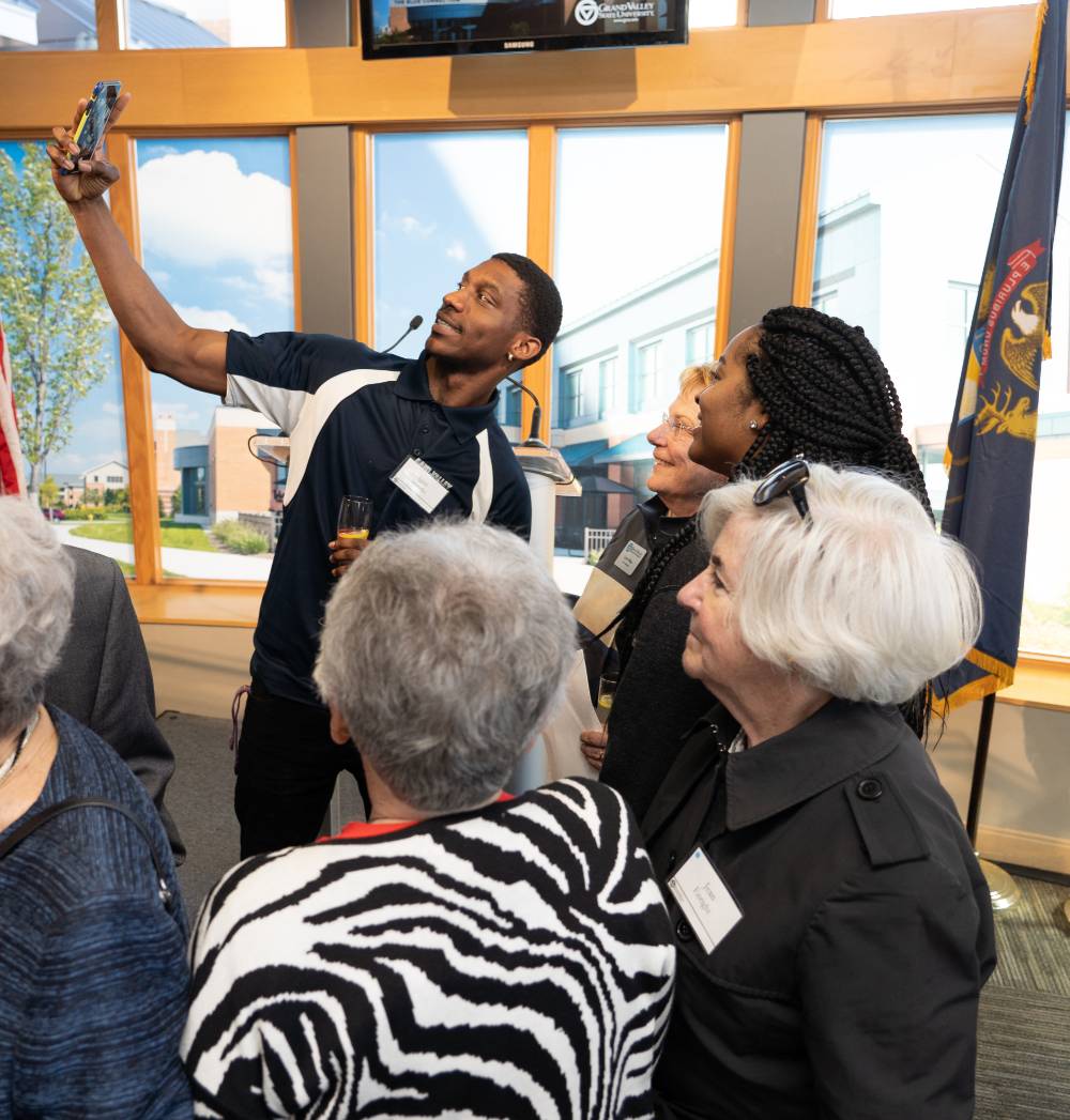 Guests taking a selfie with Lynn Blue at the Lynn M. Blue Connection Naming Ceremony